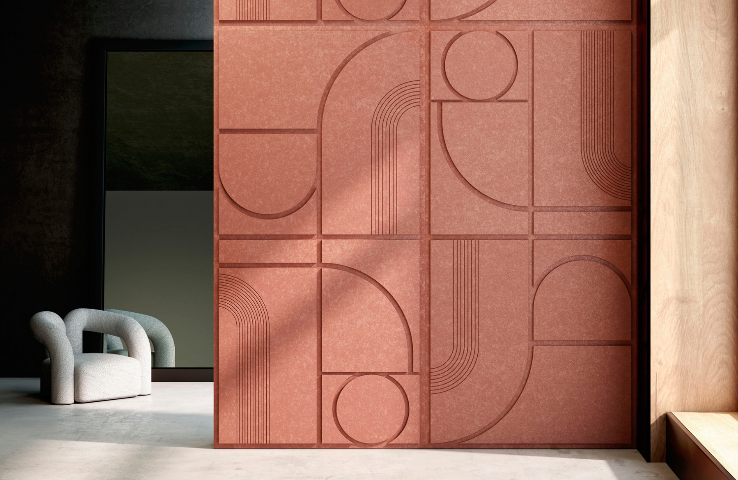Modern interior with a geometric 3D wall panel in terracotta color and a sculptural light-gray armchair beside a large mirror.